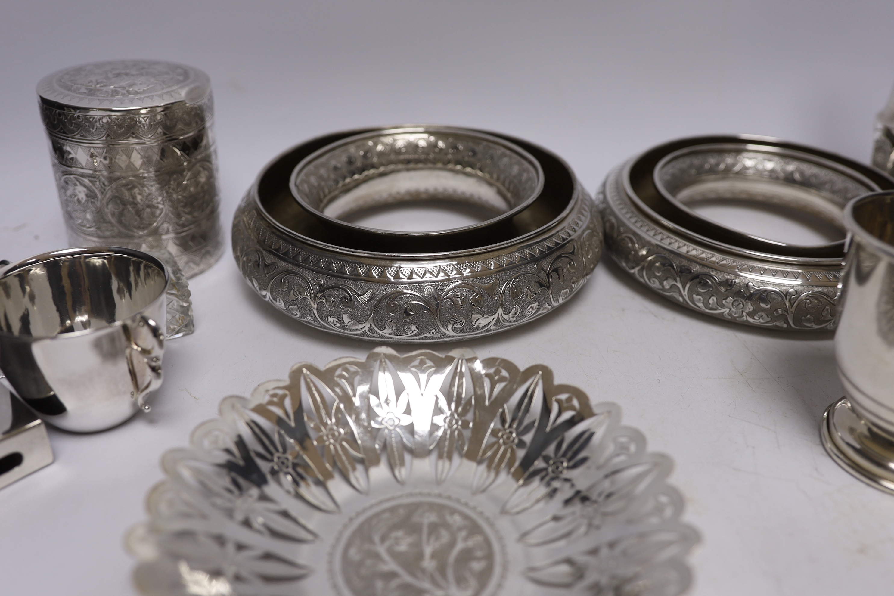 A group of silver and a white metal items including two Middle Eastern ring vases, two foliate dishes, a vase and a canister, together with a silver christening mug, 800 standard beaker, silver fish slice, two mounted gl
